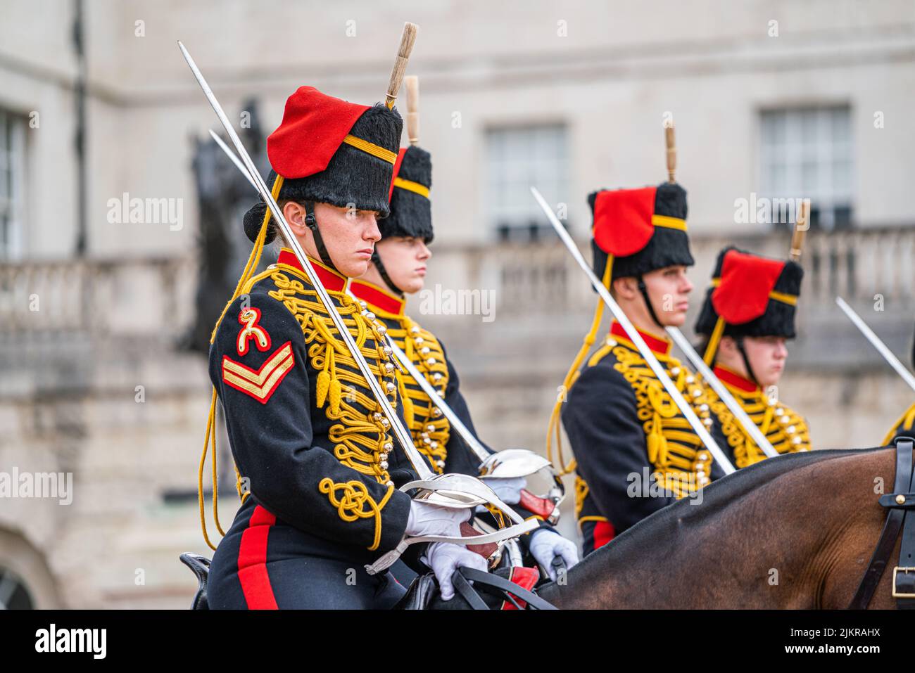 London, UK 3 August 2022. Members of the Kings Troop Horse Artillery  wearing gold braided uniforms and busby hats ride down the mall towards horse guards parade during the changing of the guards ceremony on a hot and humid day in London Credit. amer ghazzal/Alamy Live News Stock Photo