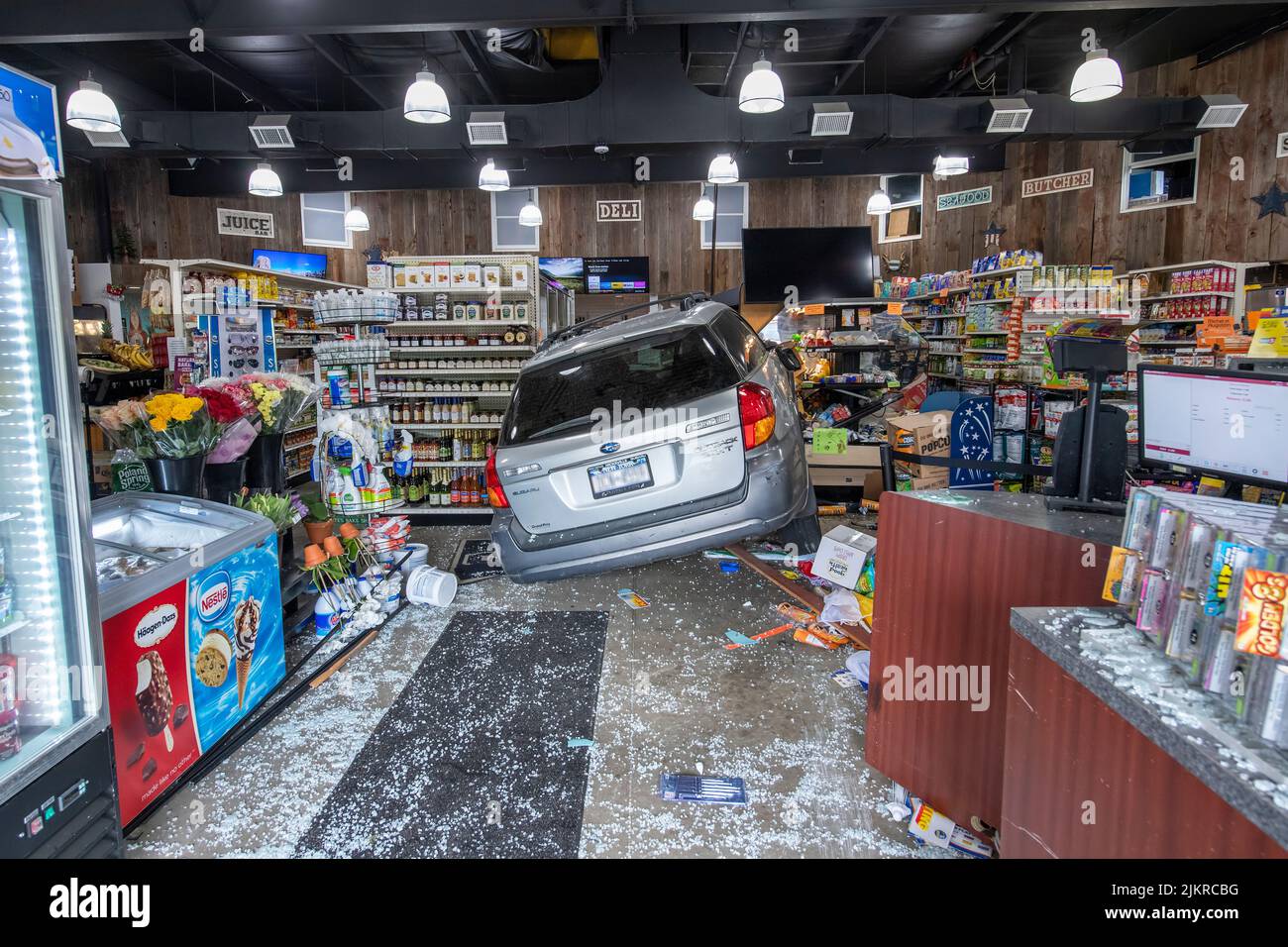 Members of the East Hampton Fire Department responded to a call of a vehicle that had driven through the front doors and into the Hampton Market at 36 Stock Photo