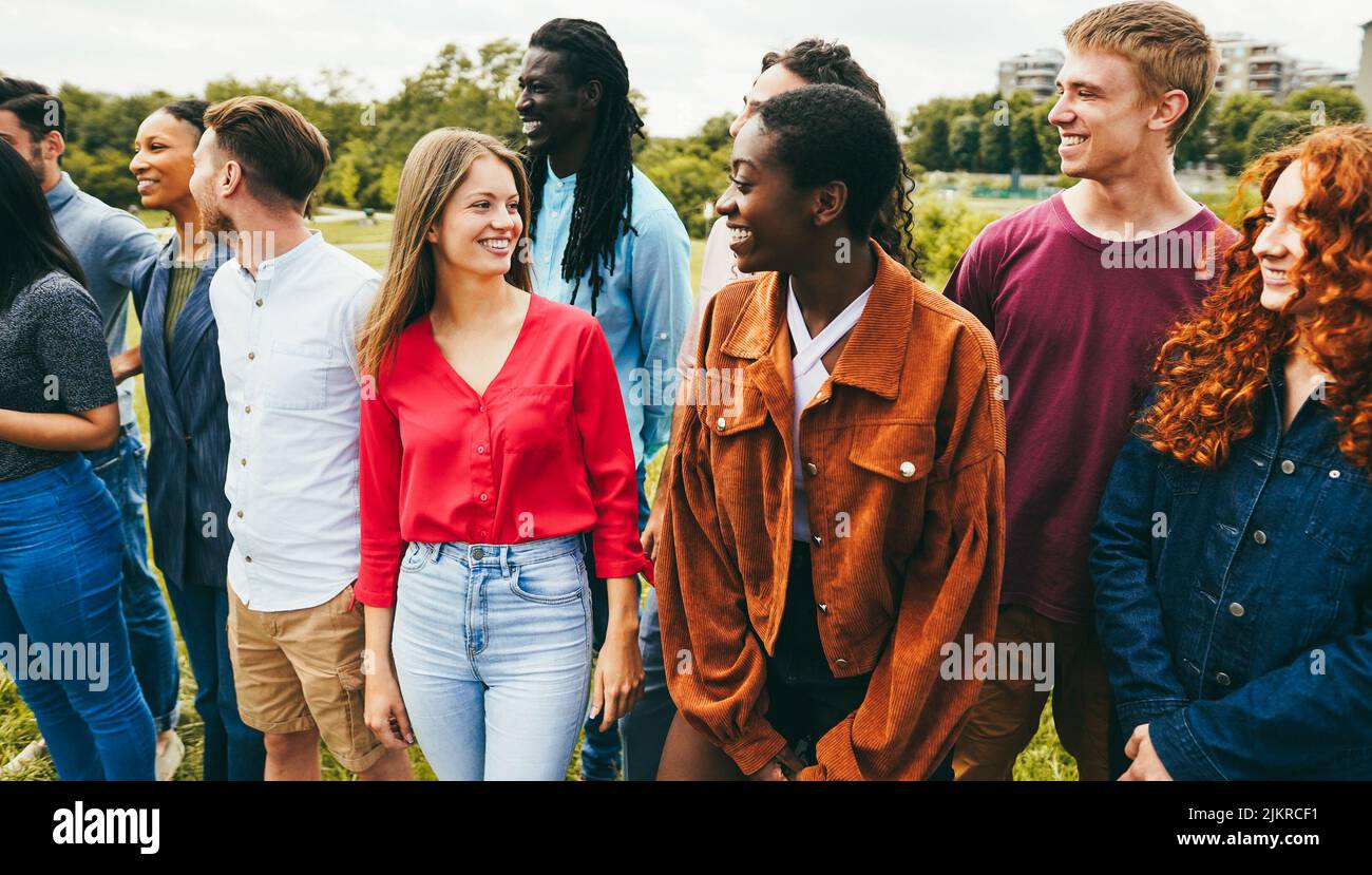 Multiracial young friends having fun outdoor - Focus on blond girl face ...