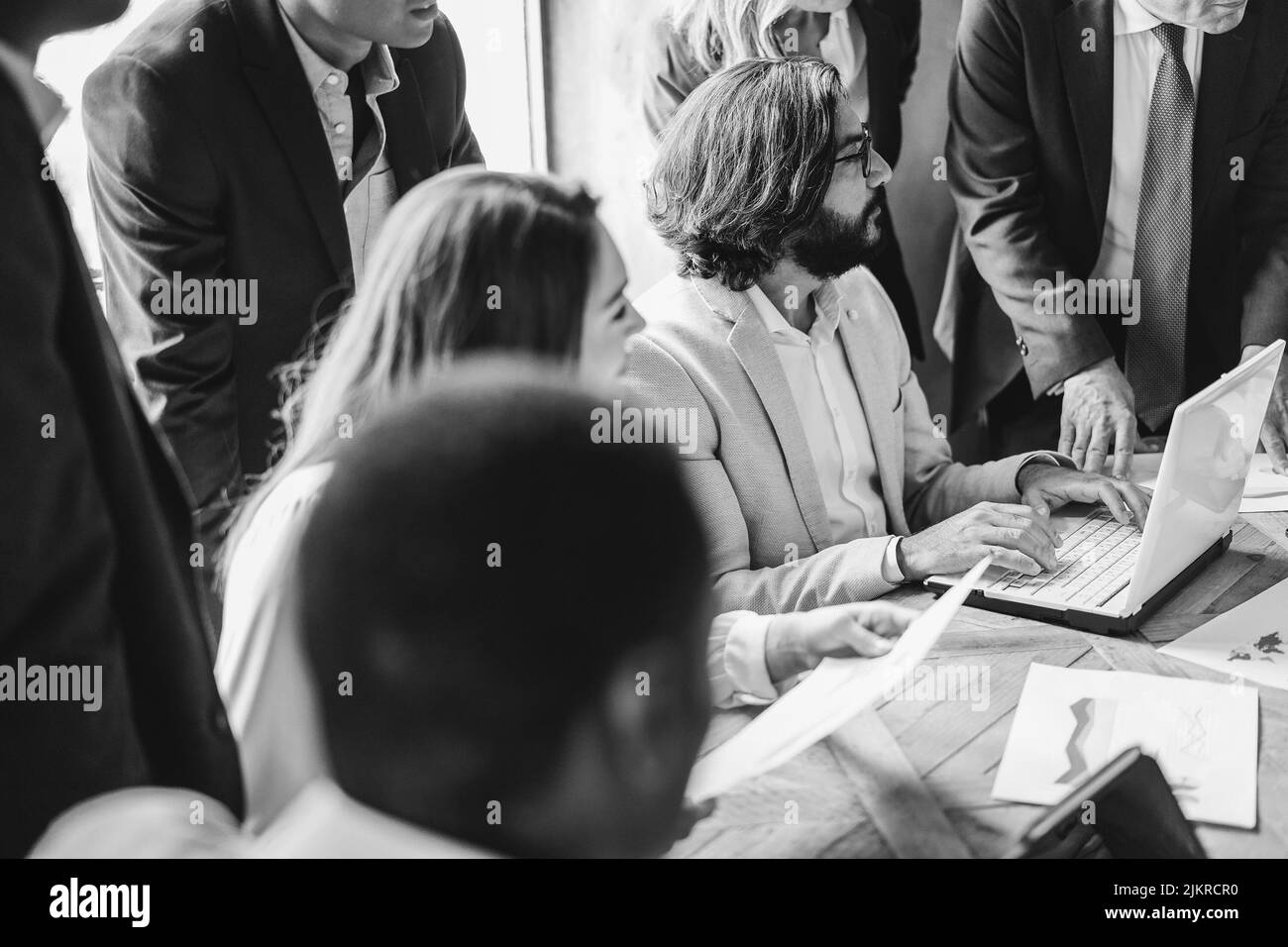 Multiracial business people working inside bank office - Focus on arabian man head - Black and white editing Stock Photo