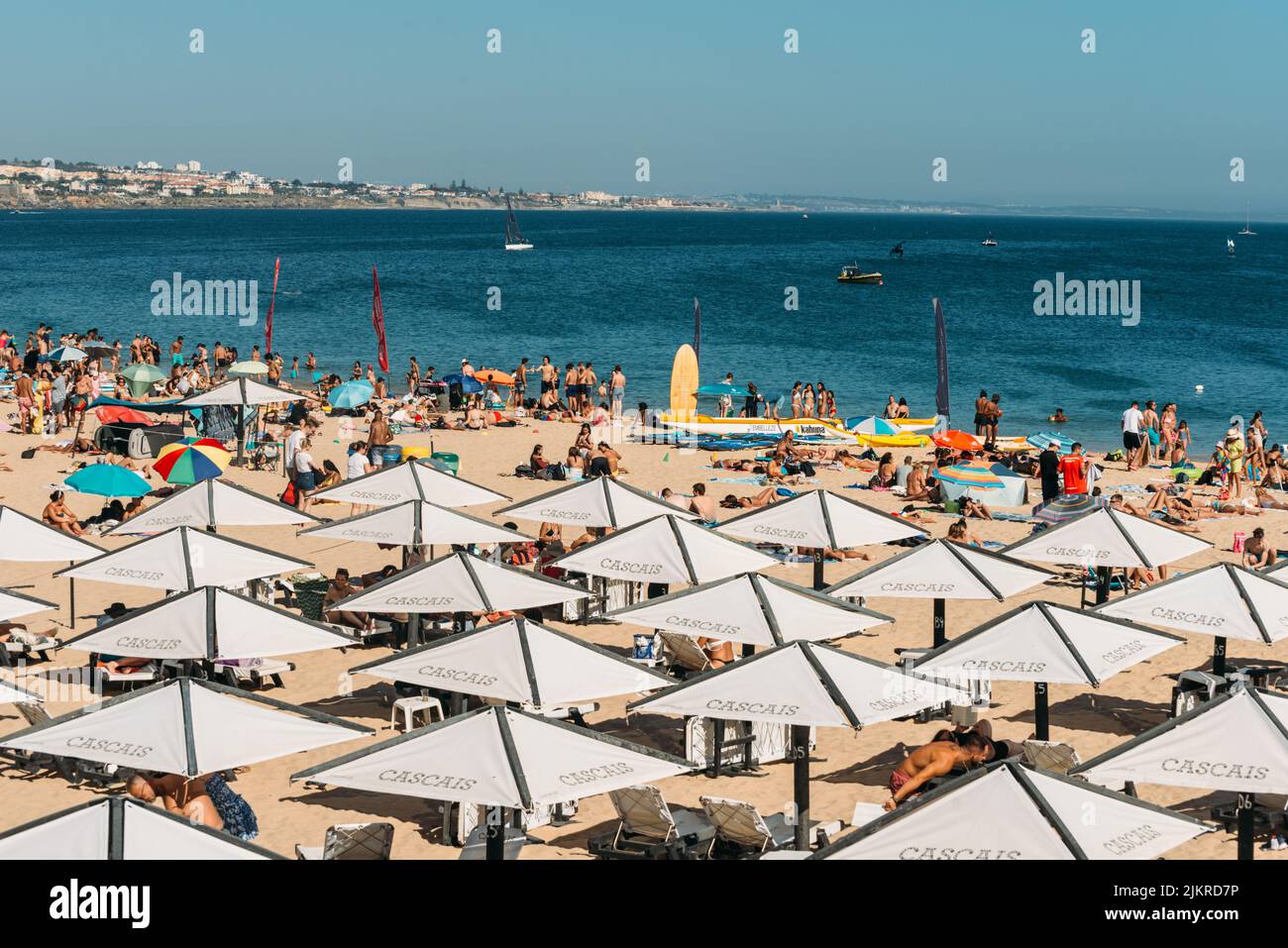 Crowded sandy Conceicao beach in Cascais near Lisbon, Portugal during the summer Stock Photo