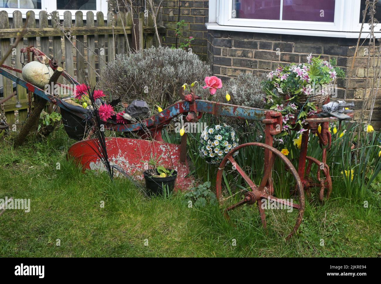 old farm plough in front garden Stock Photo