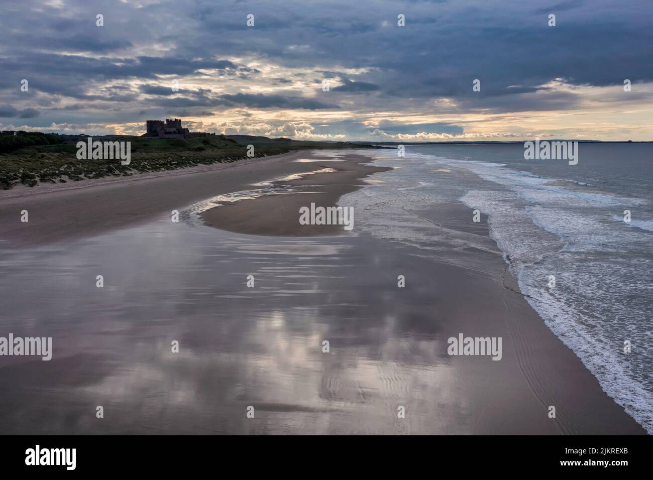 Bamburgh Castle from the beach to the south at sunset with no people elevated view Stock Photo