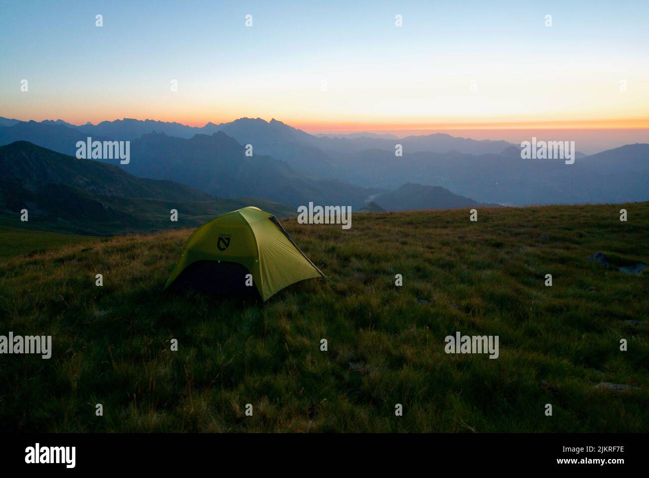 Tent on top of a mountain (Pic du Cabaliros) in the Pyrenees National Park. Hautes-Pyrénées. France. Camping on top of a mountain at sunset. Bivouac. Stock Photo