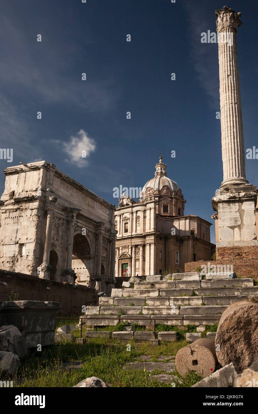 Column of Phocas and the Arch of Septimius Severus in the Roman Forum with the Church of Santi Luca e Martina in the background Stock Photo