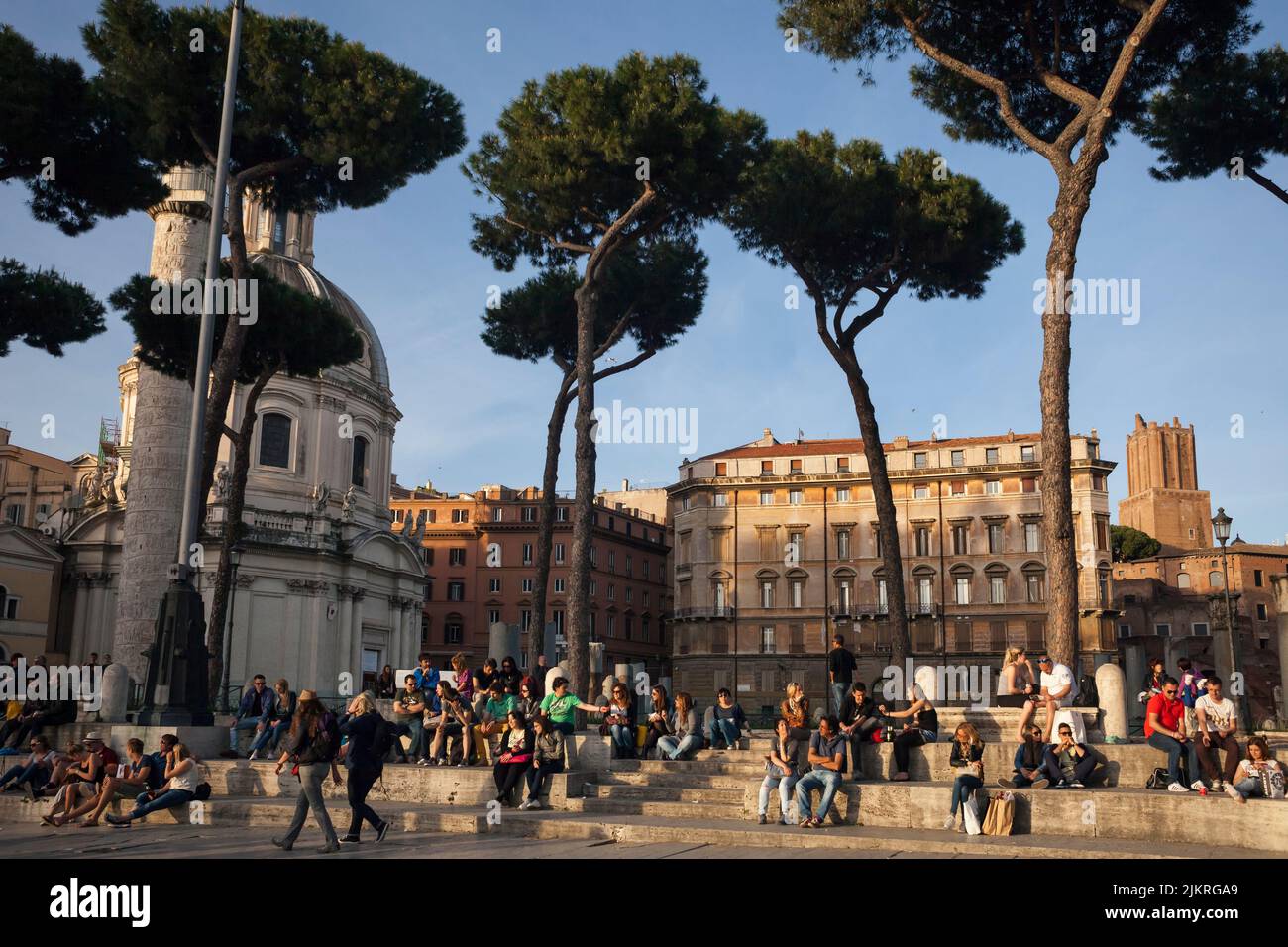 Tourists resting in Via dei Fori Imperiali, Rome Stock Photo