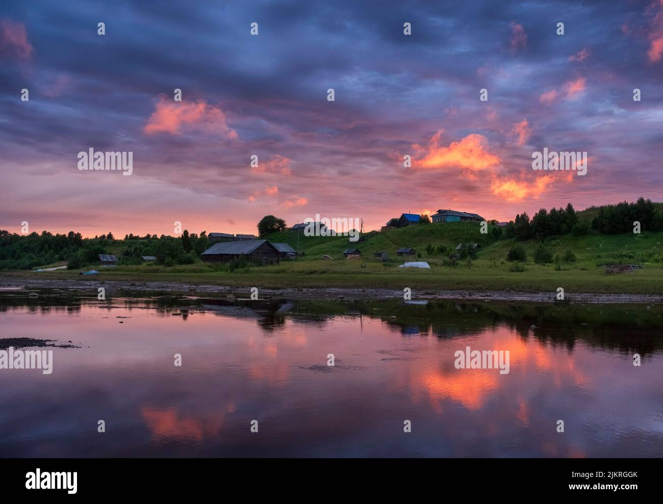 The ancient Pomeranian village of Punerma in the Arkhangelsk region, in the summer at sunset on the banks of the river Stock Photo