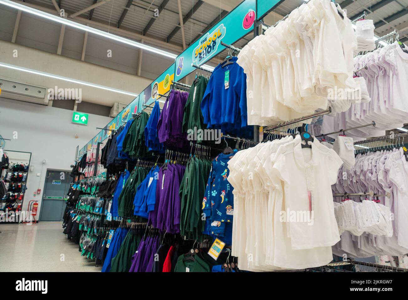 Row of school jumpers of different colours from the school shop, back to school uniform, asda, ashford, kent, uk Stock Photo