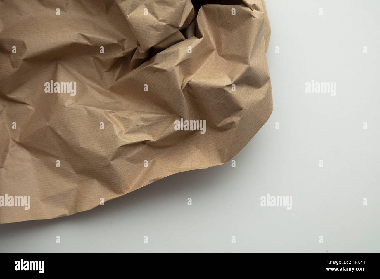 Crumpled kraft paper brown background texture. Recycle brown paper crumpled  texture. Old paper surface for background. Stock Photo