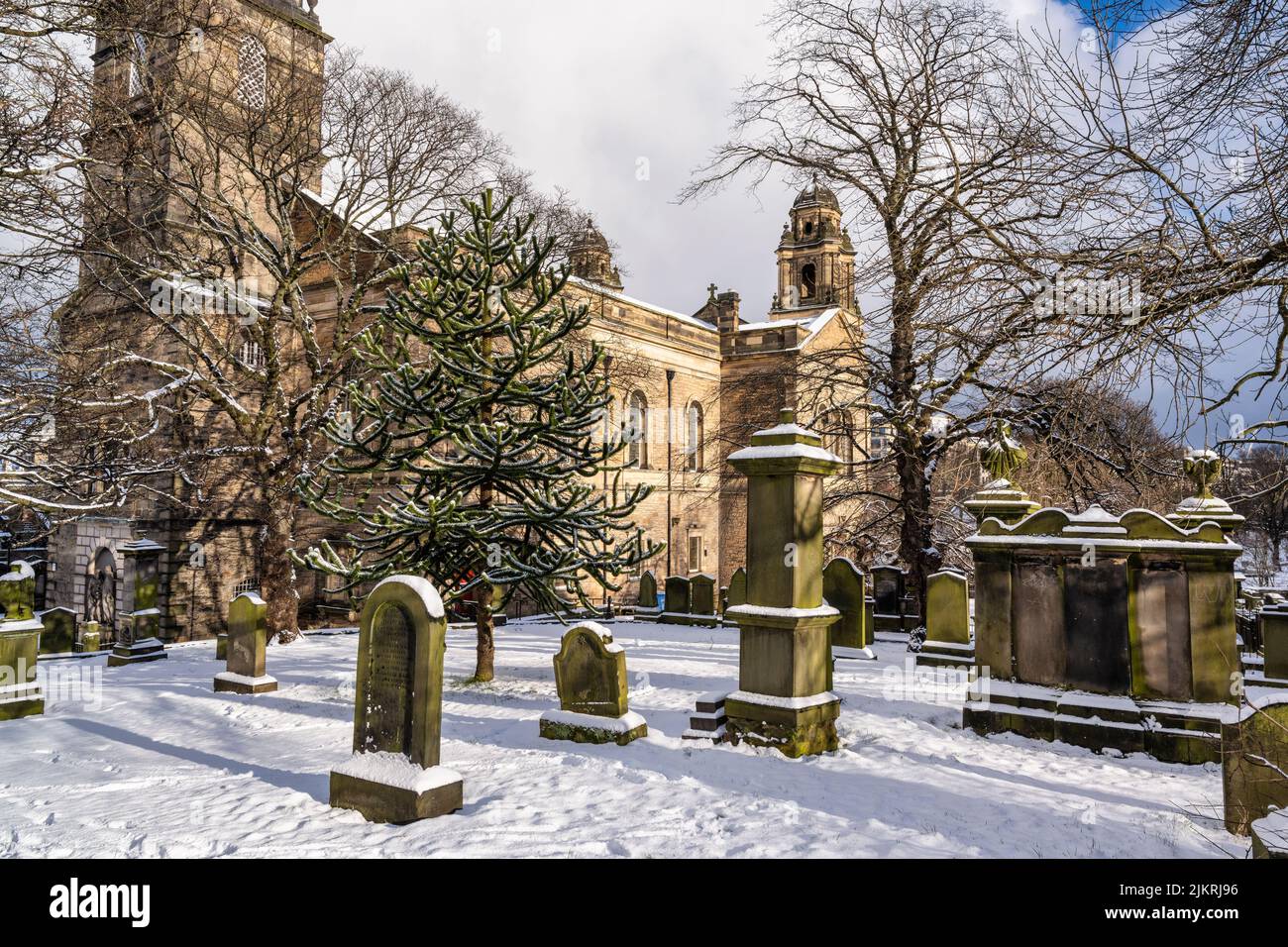 Gravestones in St Cuthbert's Graveyard with a carpet of snow in city centre of Edinburgh in Scotland, UK Stock Photo
