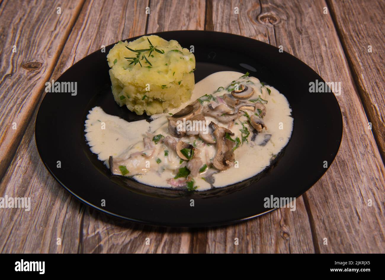 Recipe for fillet of sea bream in white wine sauce with mashed potatoes and mushrooms Stock Photo