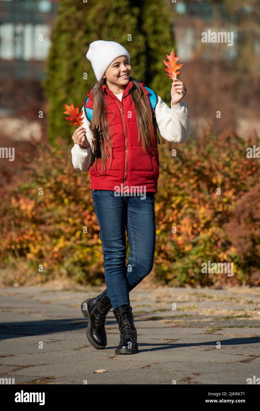 happy teen girl at school time outdoor in autumn season. full length Stock Photo