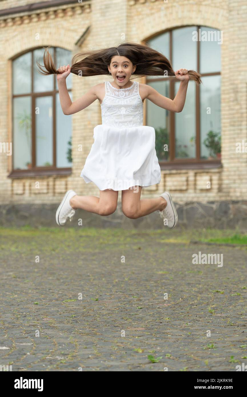 glad funny teen girl. jumping girl having fun. teenager girl jump outdoor Stock Photo