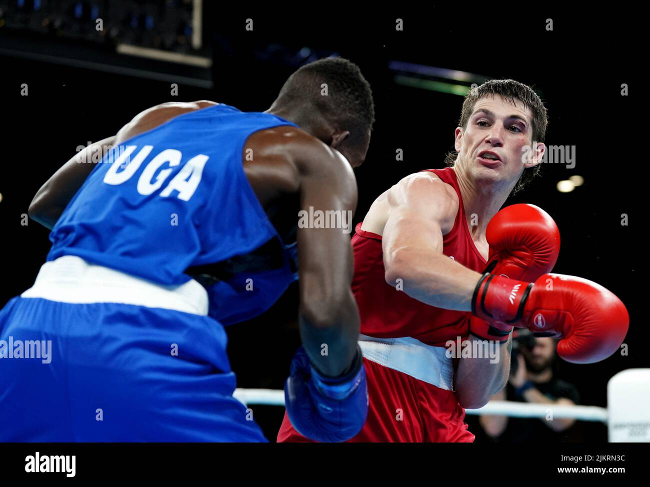 Canada's Wyatt Sanford (right) and Uganda's Joshua Tukamuhebwa during the Men's Over 60kg-63.5kg (Light Welter) - Quarter-Final 2 at The NEC on day six of the 2022 Commonwealth Games in Birmingham. Picture date: Wednesday August 3, 2022. Stock Photo