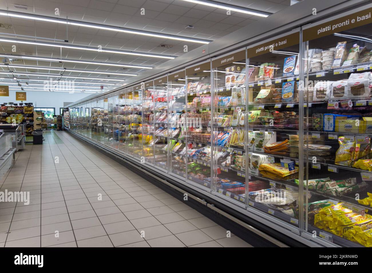 Fossano, Cuneo, Italy - August 02, 2022: Long refrigerator shelving with ready-to-eat foods and salami packaged in Italian supermarket of the Mercatò Stock Photo