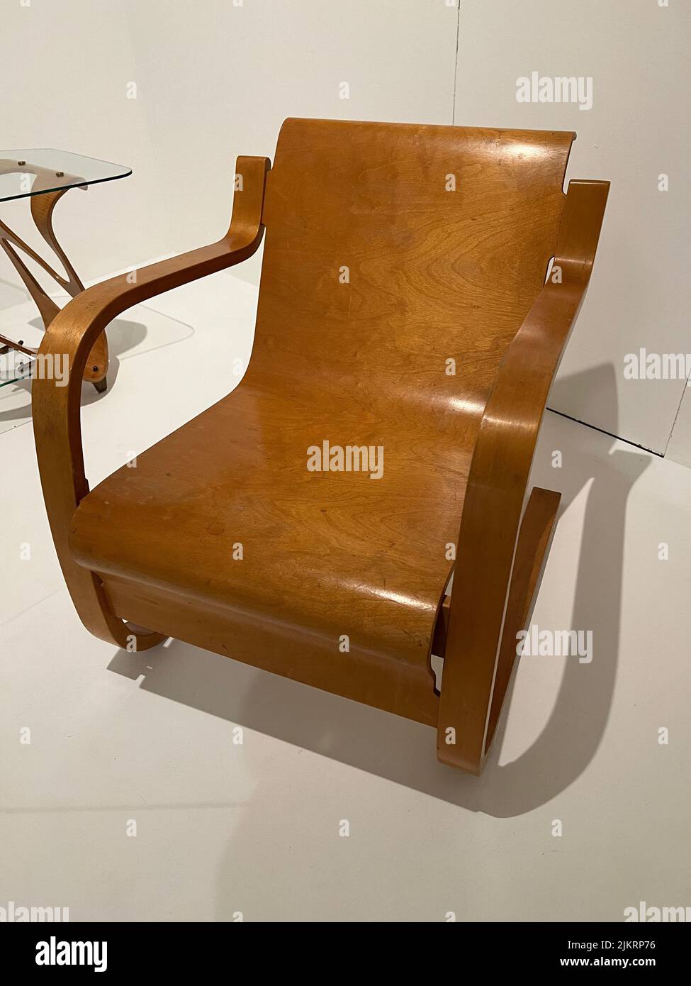 The Finnish designer Alvar Aalto created the Model 31 Chair, formed from a single sheet of molded plywood.Though it was already being used in the nineteenth century, molded plywood-sheets of wood veneer laminated with glue and formed under heat and pressure-became ubiquitous in the mid-twentieth century as a relatively affordable means of producing, and democratizing, 'good design.' Many of the leading designers of the period experimented with the material to create some of their most iconic works. In the early 1930s. Stock Photo