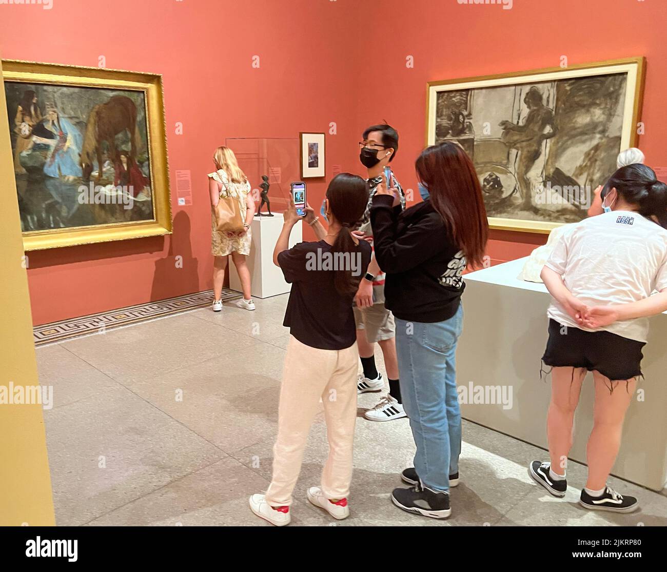 Cell phones have become an integral part of the museum experience, by documenting and remembering the art they see. Brooklyn Museum, Brooklyn, NY. Stock Photo