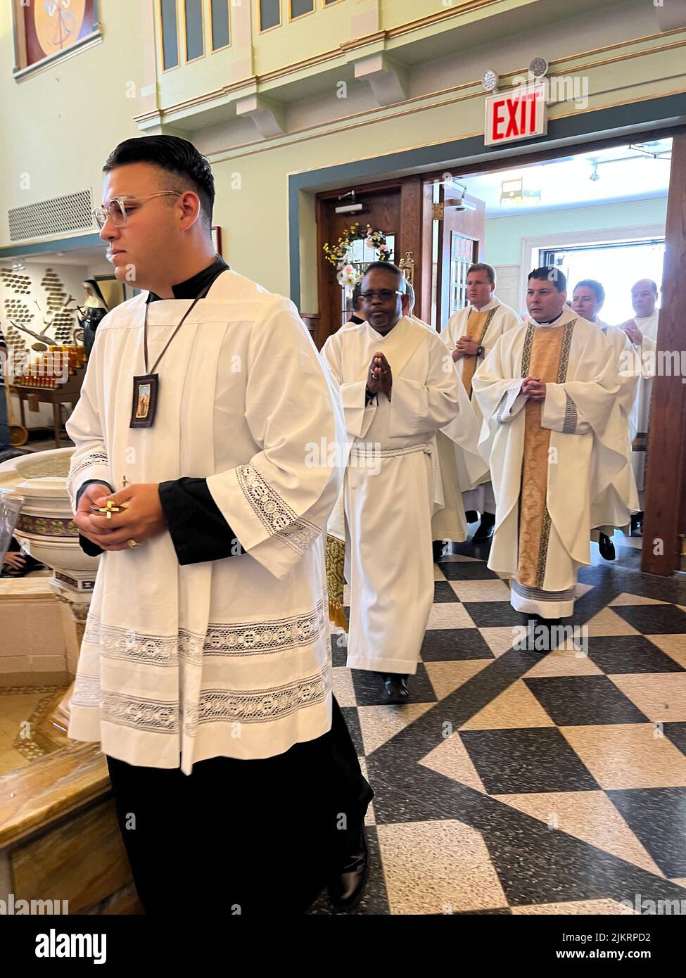 Clergy procession to the alter for mass at Our Lady of Mount Saint Carmel in Williamsburg Brooklyn; New York. Stock Photo