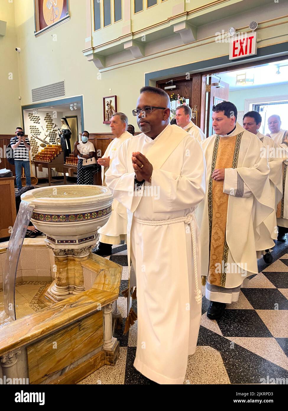 Clergy procession to the alter for mass at Our Lady of Mount Saint Carmel in Williamsburg Brooklyn; New York. Stock Photo
