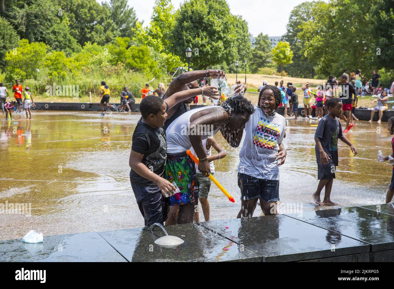 Children having fun and cooling off on a very hot summer day in the waterpark at the LeFrak Center at Lakeside in Prospect Park, Brooklyn, New York Stock Photo