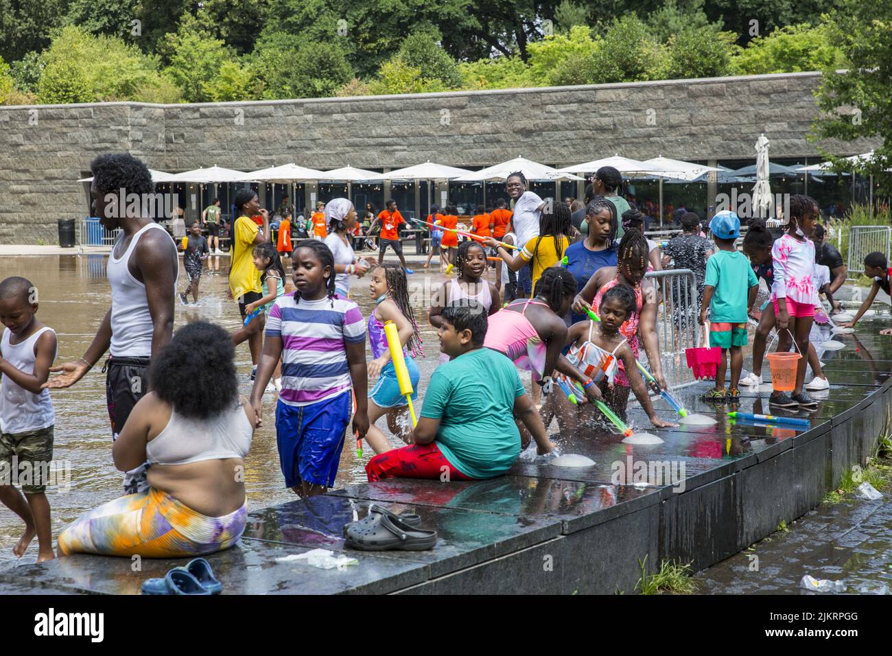 Children having fun and cooling off on a very hot summer day in the waterpark at the LeFrak Center at Lakeside in Prospect Park, Brooklyn, New York Stock Photo