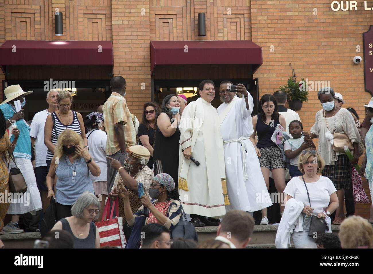 Priests lead a procession outside Our Lady of Mount Saint Carmel Church at the during the annual Giglio Feast in Williamsburg, Brooklyn, New York. Stock Photo