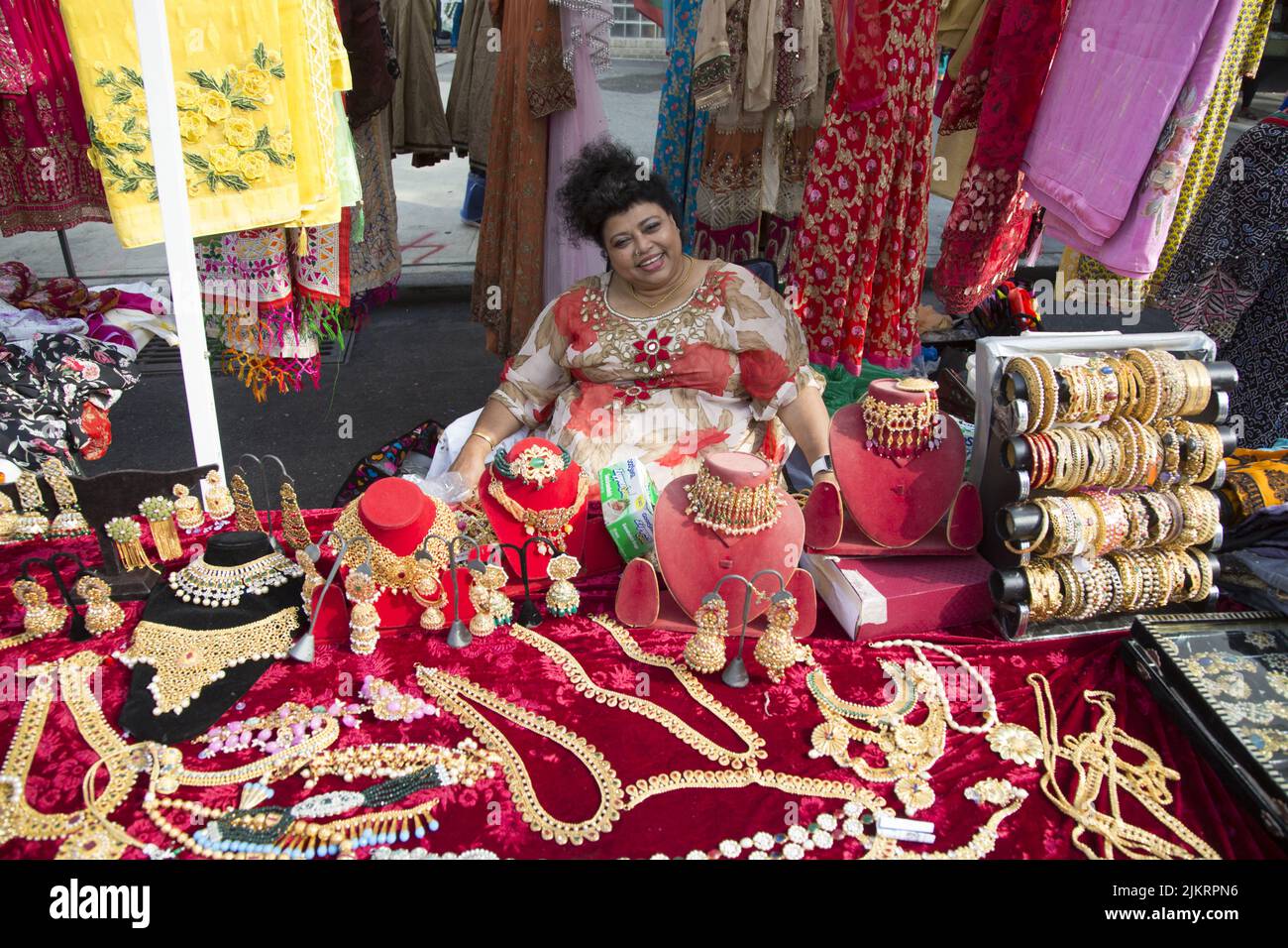 Woman sells women's clothing and jewelry at a Bangladeshi street fair on Church Avenue in the multiethnic, multicultural Kensington neighborhood of Brooklyn, New York. Stock Photo