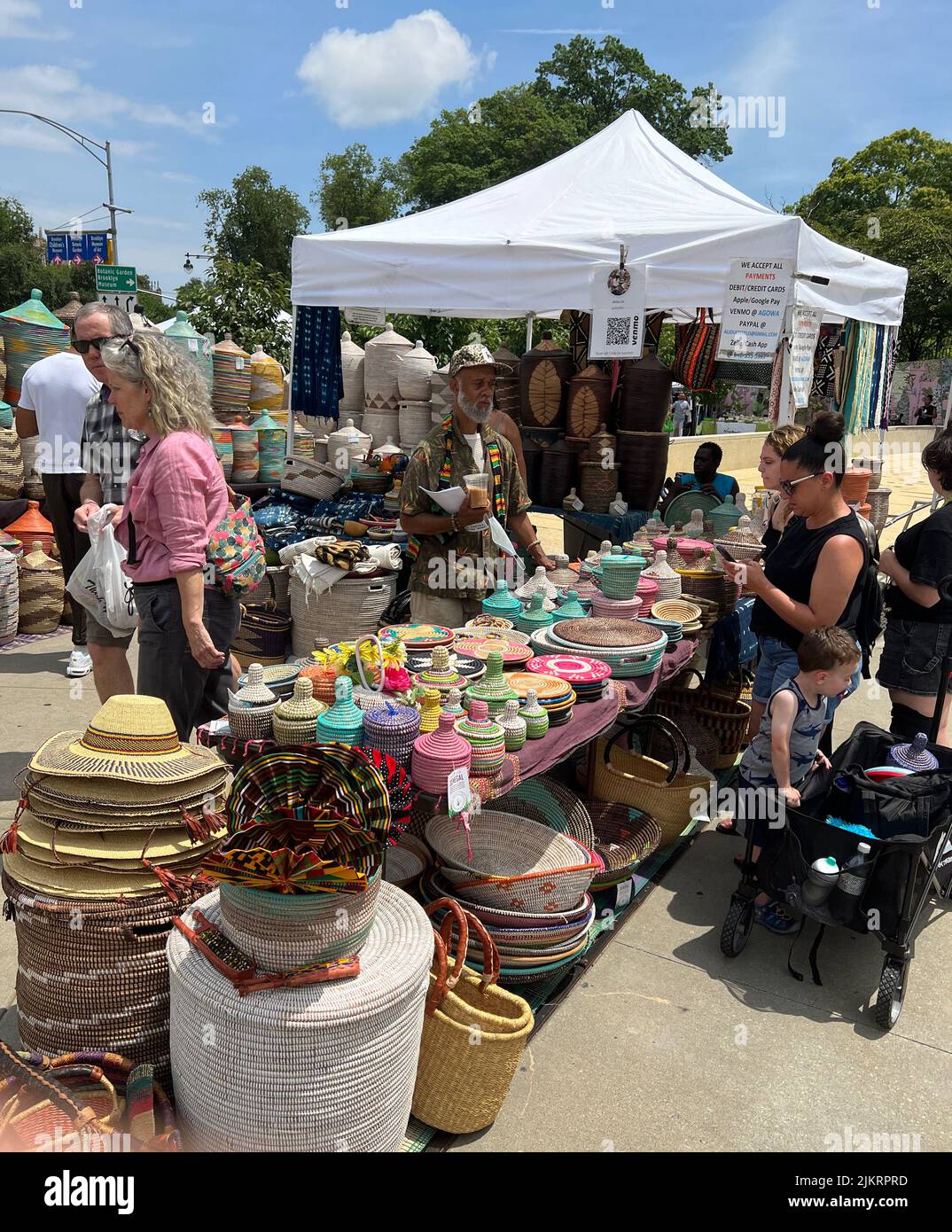Beautifully crafted streaw baskets and hats for sale by a vendor at a crafts fair in front of the Brooklyn Museum on Easteren Parkway in Brooklyn, New York. Stock Photo