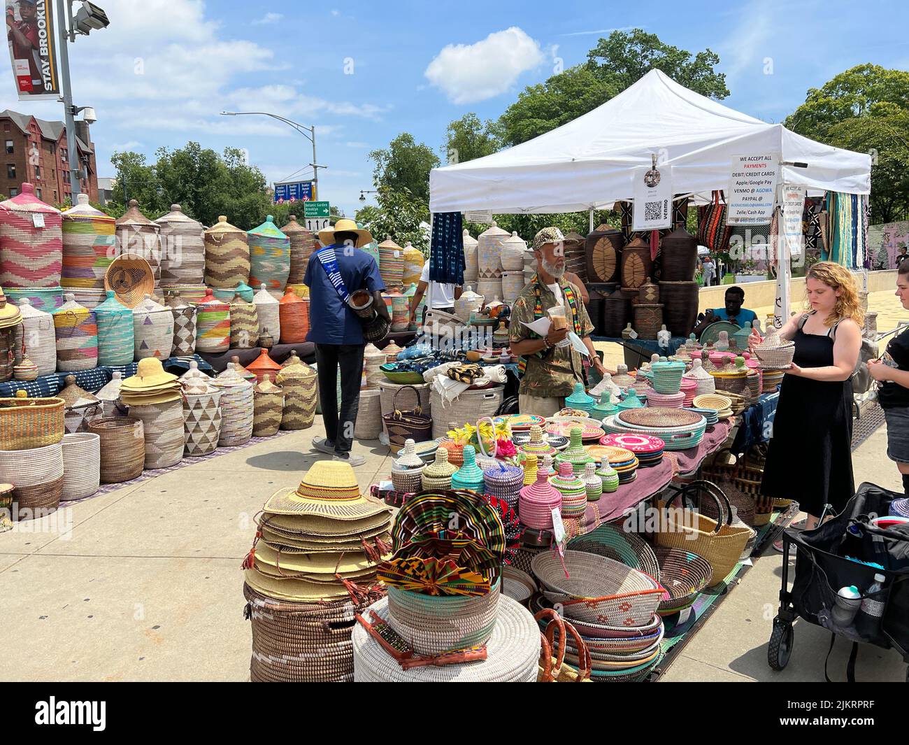 Beautifully crafted streaw baskets and hats for sale by a vendor at a crafts fair in front of the Brooklyn Museum on Easteren Parkway in Brooklyn, New York. Stock Photo