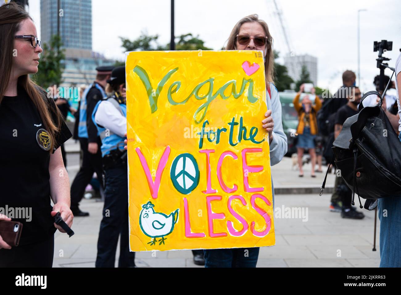 Animal rights activist holding sign saying Vegan For The Voiceless, London 2021 Stock Photo