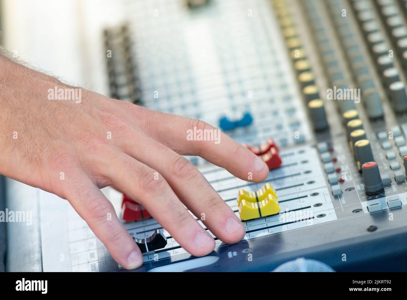 Sound Engineer Operating Professional Sound Mixer at Live Concert, Hand Stock Photo