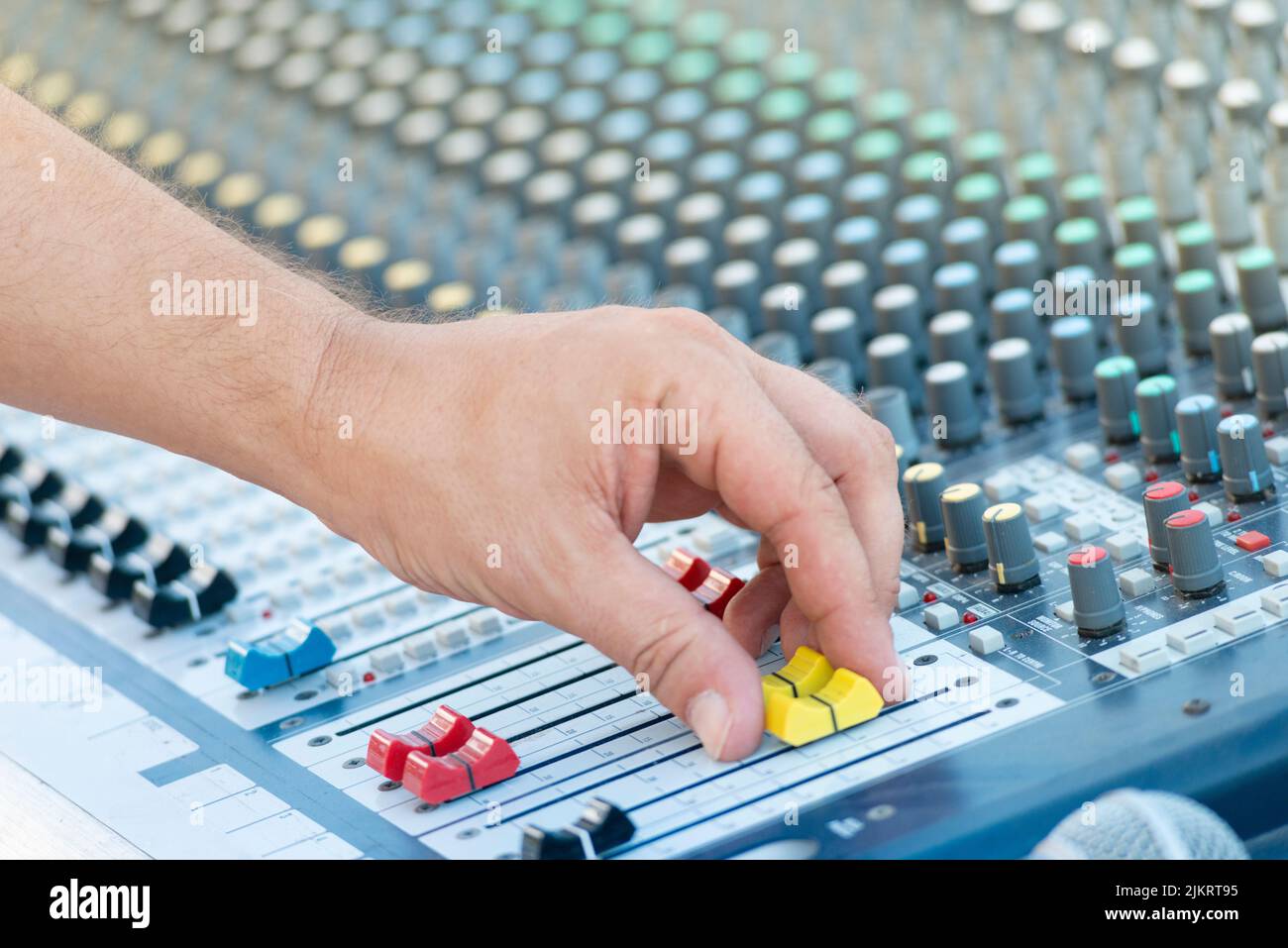 Sound Engineer Operating Professional Sound Mixer at Live Concert, Hand