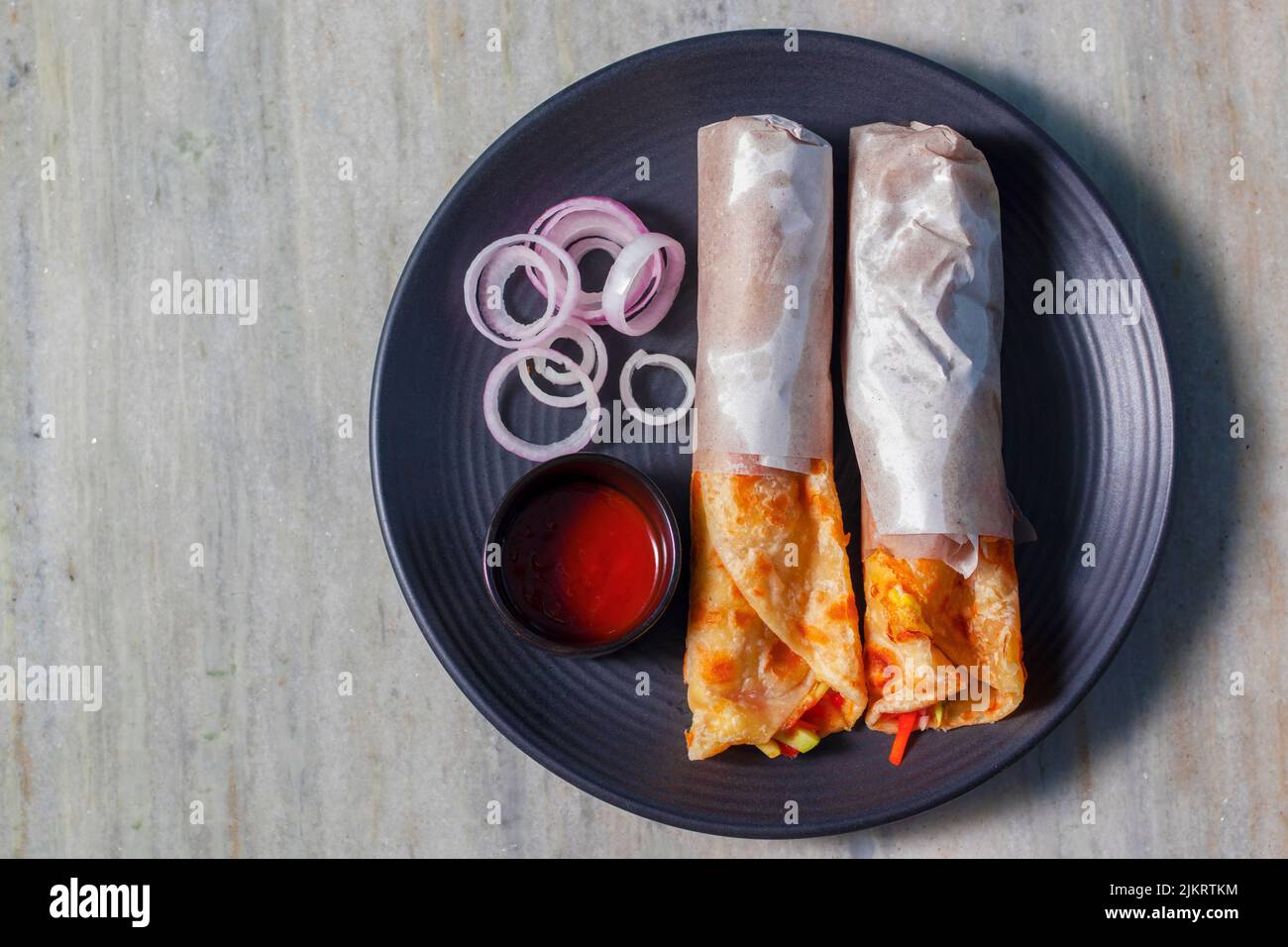 delicious Indian street food 'egg rolls' is ready to eat. Stock Photo