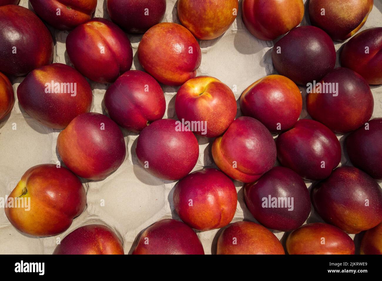 Nectarines in cassette for sale, top view of peaches Necatrines ripe Stock Photo