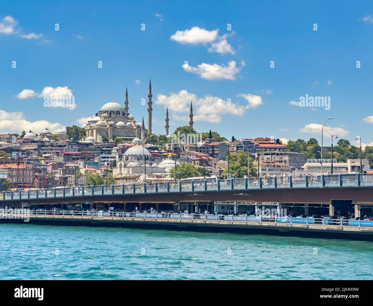 Galata bridge, Yeni Cami (New Mosque) and Suleymaniye Mosque in a row. Beautiful entrance of the Golden Horn in Istanbul Turkey, on a sunny day. Stock Photo