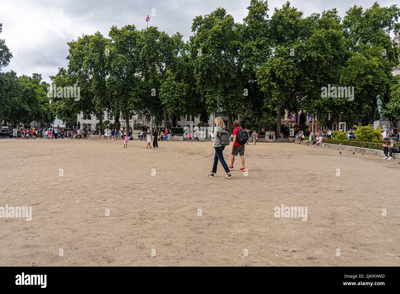 London, UK 3 August 2022. Tourists walk on a parched parliament square from the effect of the dry weather and extreme heat .  A drought warning has been declared after the hottest  july was recorded  and a historic  heatwave caused temperatures to reach 40celsius  and the south east of England  saw an average of 5mm of rain Credit. amer ghazzal/Alamy Live News Stock Photo
