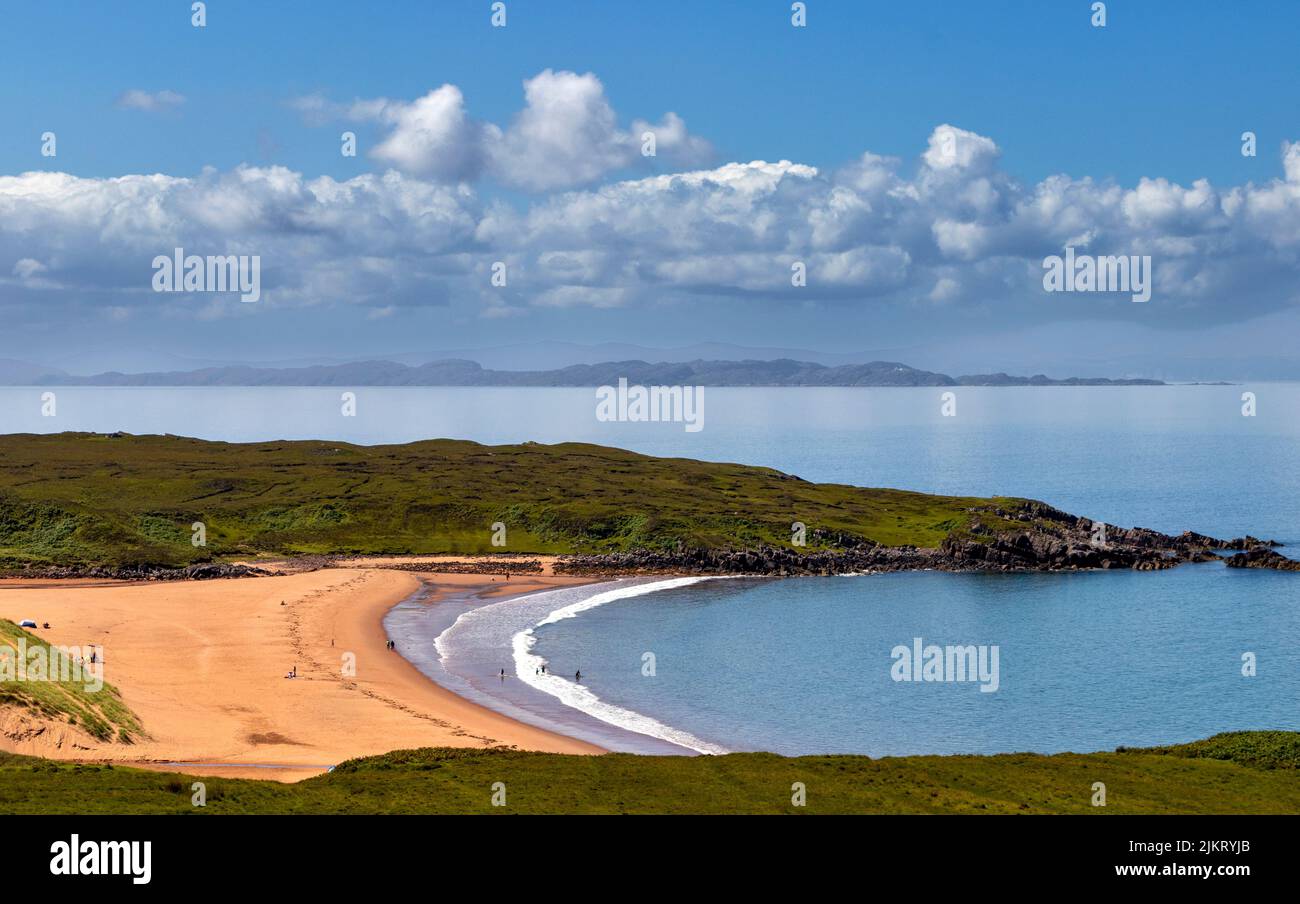 RED POINT BEACH ROSS AND CROMARTY SCOTLAND PEOPLE AND TENTS ON THE RED SANDS SKYE IN THE DISTANCE Stock Photo