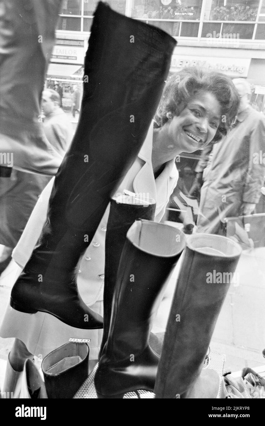NANCY WILSON (19372018) American singer shopping for boots on Oxford Street, London, in