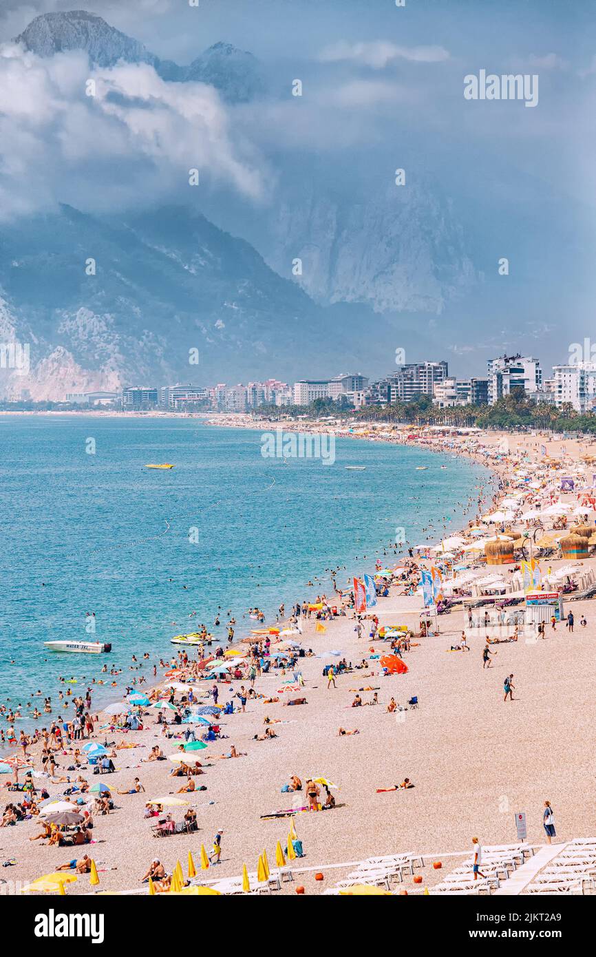 04 June 2022, Antalya, Turkey Crowded city beach with hundreds of