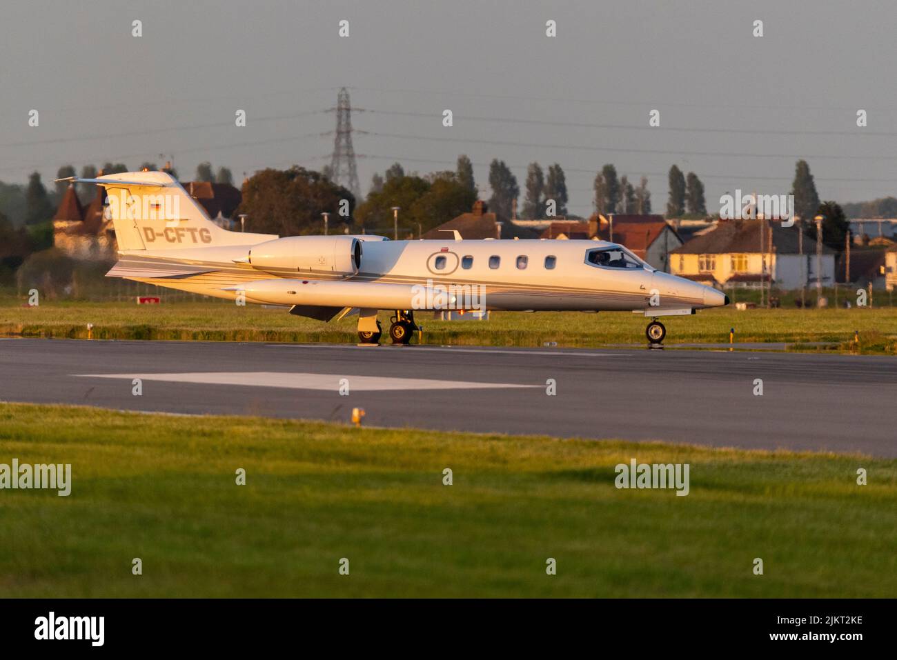 Gates Learjet 35A private jet plane D-CFTG of Quick Air Jet Charter GmbH after evening landing at London Southend Airport, Essex, UK. Sunset glow Stock Photo