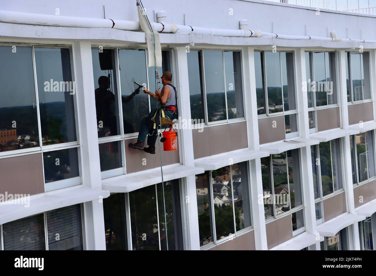 Window cleaner hanging on ropes on 30story building in Northeast Ohio