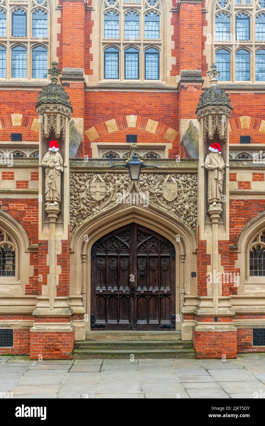UK, England, Cambridge, University of Cambridge, St. John's College,  Old Divinity School, Statues decorated with Santa Hats Stock Photo