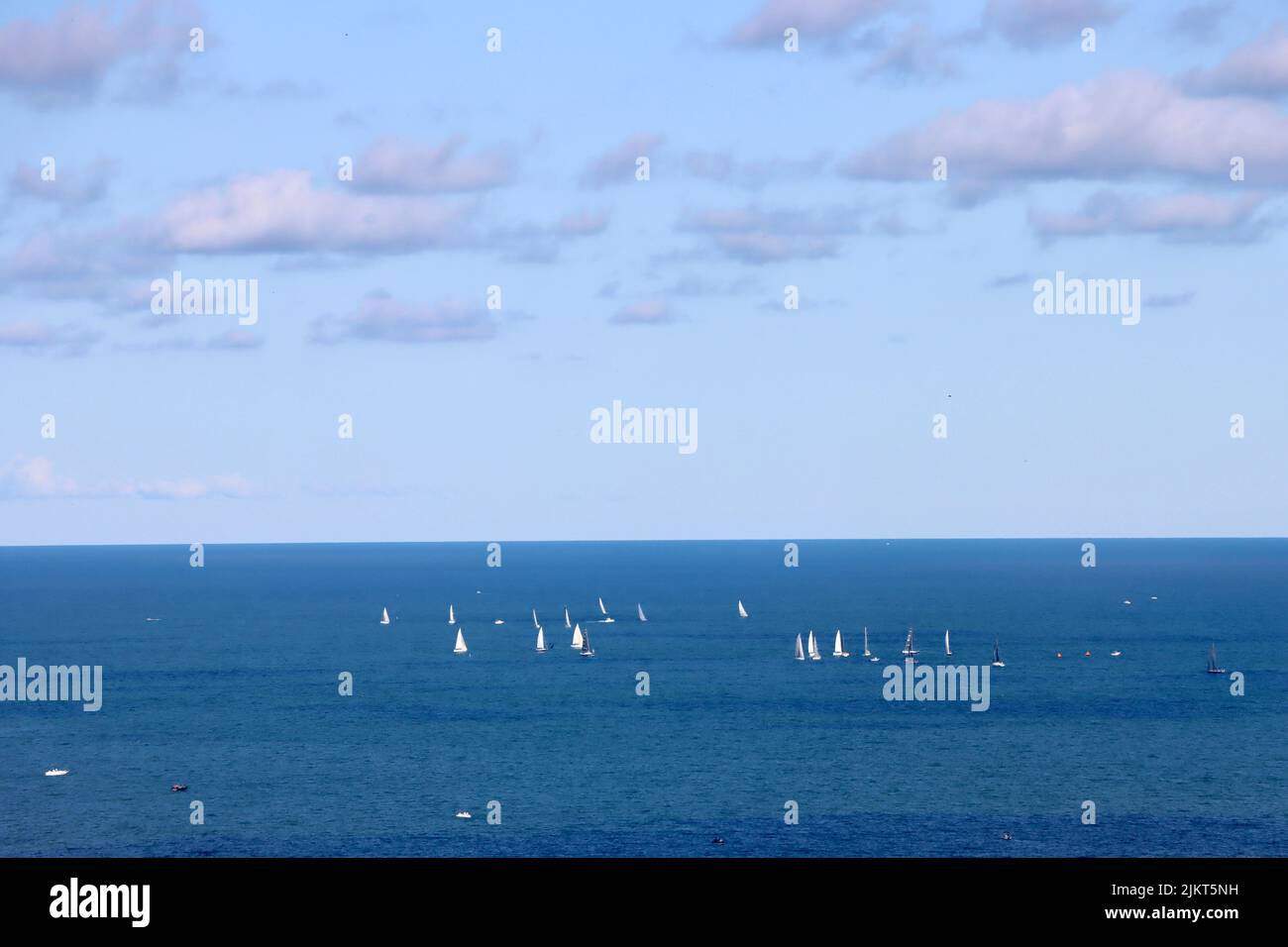 Sail boats far out on Lake Erie late July 2022 Stock Photo