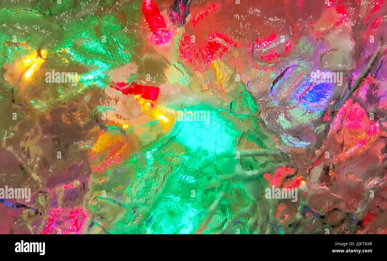 Colored lights seen through frosted glass. Defocused abstract luminous