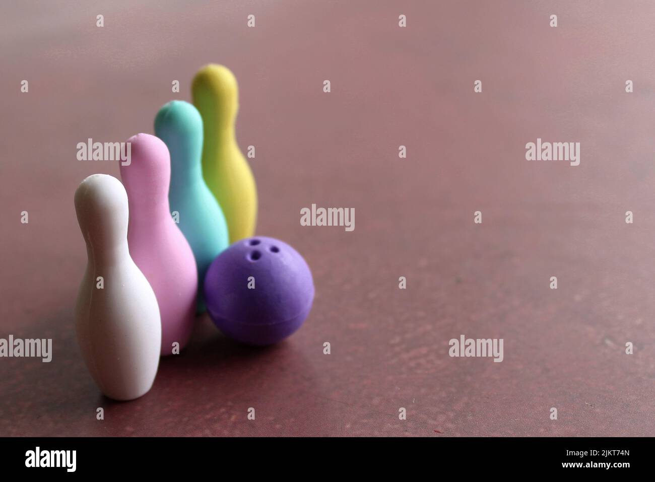 Selective focus image of bowling ball and colorful bowling pins with copy space. Stock Photo