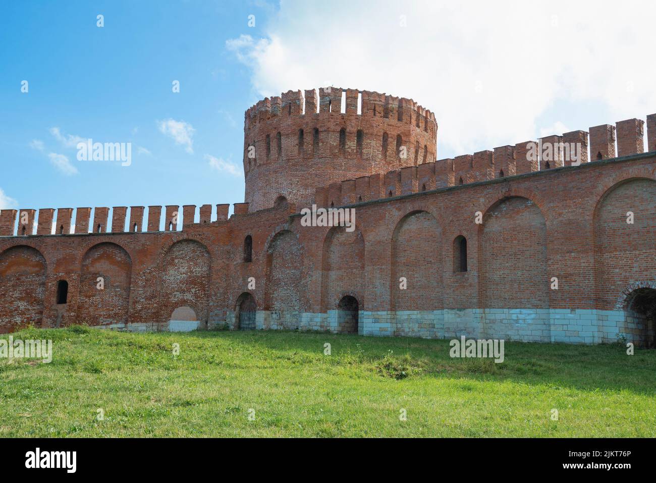 A fragment of an old city defensive wall and the Eagle Tower on a sunny July day. Smolensk, Russia Stock Photo