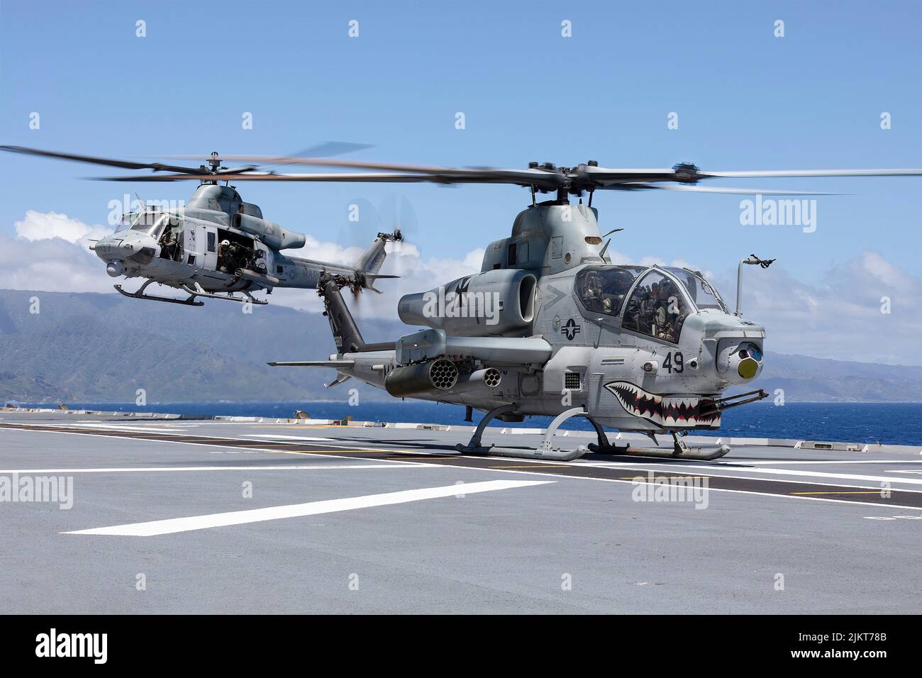 Pacific Ocean, United States. 01 August, 2022. A U.S. Marine Corps AH-1Z Viper attack helicopter and a UH-1Y Venom helicopter launch from the flight deck of Royal Australian Navy Canberra-class landing helicopter dock ship HMAS Canberra during an amphibious assault at the Rim of the Pacific exercise, July 28, 2022 off the coast of Hawaii, USA.  Credit: Seaman Matthew Lyall/US Navy/Alamy Live News Stock Photo