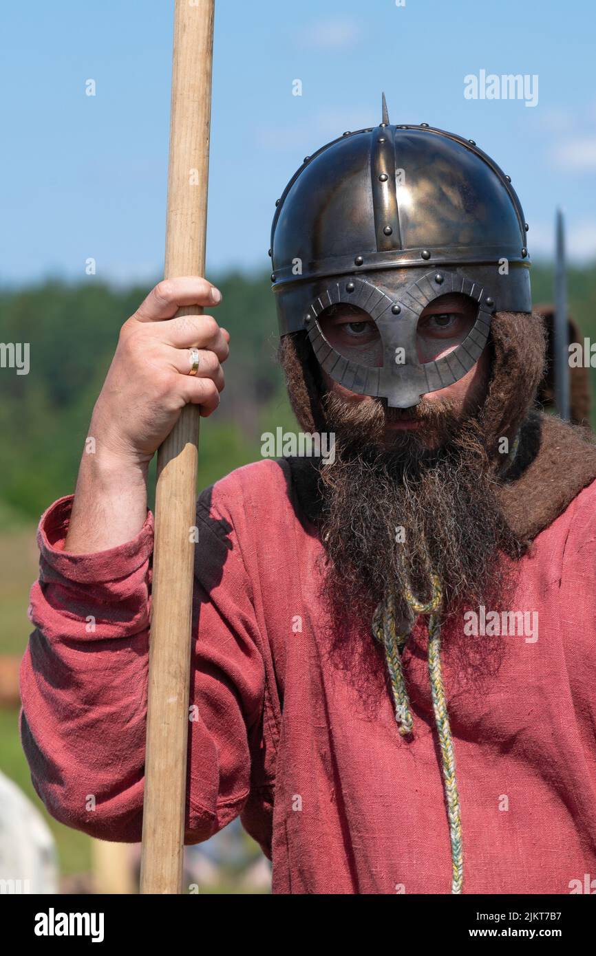 TVER REGION, RUSSIA - JULY 23, 2022: Portrait of a spearman in a medieval helmet (Norman, Scandinavian helmet) on a sunny summer day. Historical festi Stock Photo