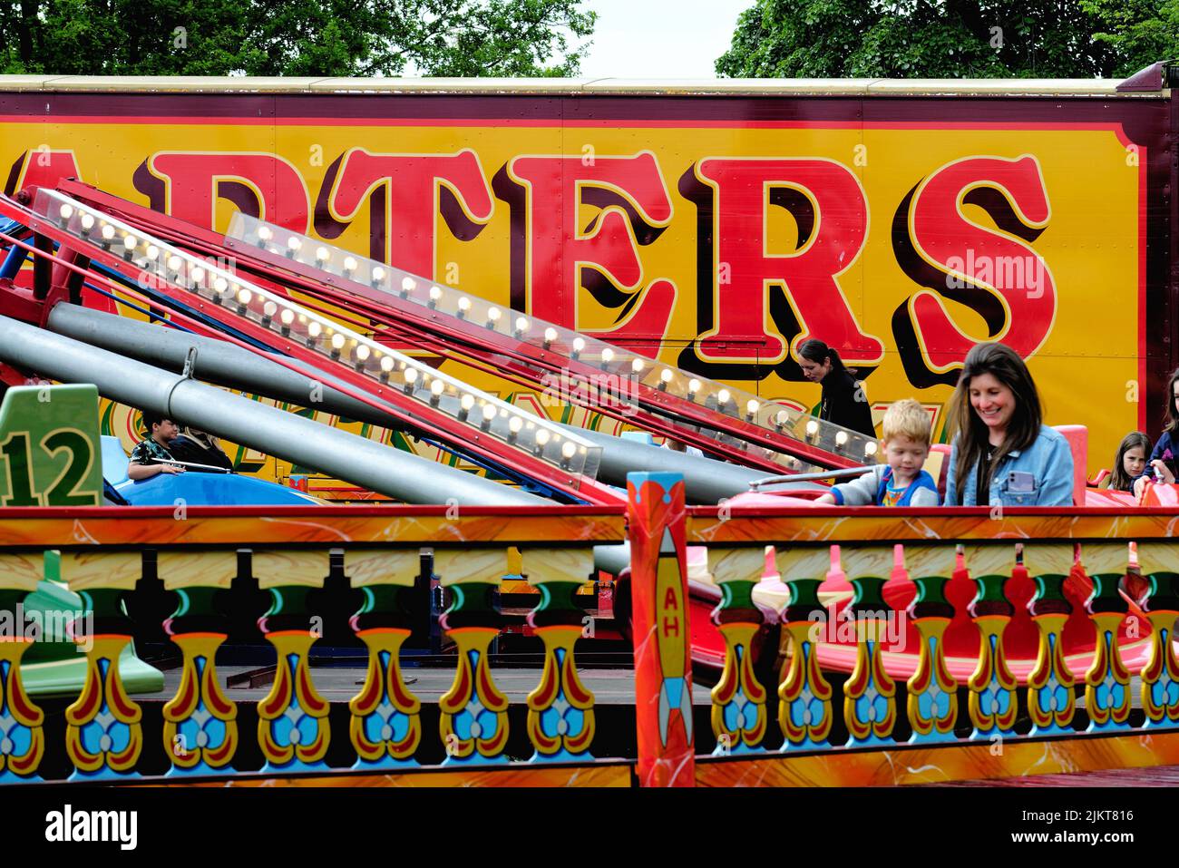 The traditional and colourful Carters Steam Fair being enjoyed by crowds on a summers day in Surrey England UK Stock Photo