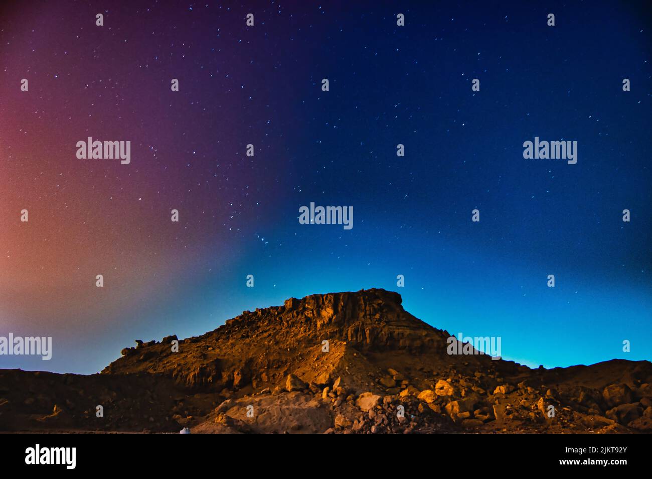 A mesmerizing scene of a Starry night Rocky hill realistic Very saturated Sky vista Stars Stock Photo